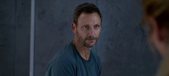 Movie still from “Chambers” (2019), created by Leah Rachel – A person wearing a blue t - shirt; Close Up shot, High angle