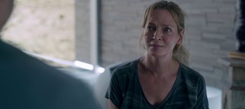 Movie still from “Chambers” (2019), created by Leah Rachel – A person sitting on a couch; Close Up shot, Over the shoulder angle