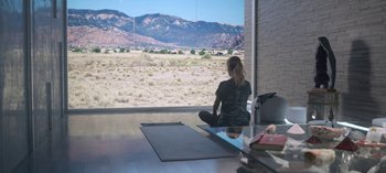 Movie still from “Chambers” (2019), created by Leah Rachel – A woman sitting in front of an open window; Wide shot, Over the shoulder angle
