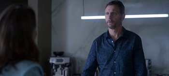 Movie still from “Chambers” (2019), created by Leah Rachel – A man standing in front of a coffee machine; Medium shot, Over the shoulder angle