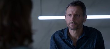 Movie still from “Chambers” (2019), created by Leah Rachel – A person wearing a blue shirt; Close Up shot, Over the shoulder angle