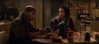 Movie still from “Chambers” (2019), created by Leah Rachel – A man and a woman sitting at a table; Medium shot, Over the shoulder angle