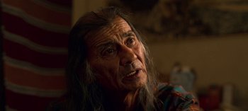 Movie still from “Chambers” (2019), created by Leah Rachel – An old man with long hair and a mustache; Close Up shot, Over the shoulder angle