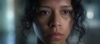 Movie still from “Chambers” (2019), created by Leah Rachel – A woman's face with a dark background; Extreme Close Up shot, Low angle