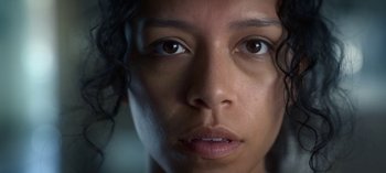 Movie still from “Chambers” (2019), created by Leah Rachel – A woman's face with a lot of light coming on; Extreme Close Up shot, Low angle