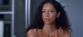 Movie still from “Chambers” (2019), created by Leah Rachel – A person with long black curly hair; Close Up shot, Low angle