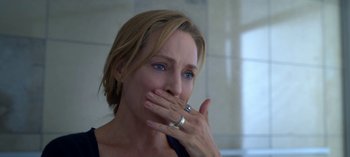 Movie still from “Chambers” (2019), created by Leah Rachel – A person covering her mouth with her hand; Close Up shot, Over the shoulder angle