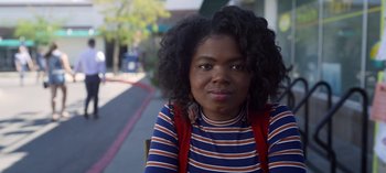 Movie still from “Chambers” (2019), created by Leah Rachel – A young woman sitting on the side of the street; Close Up shot, Over the shoulder angle