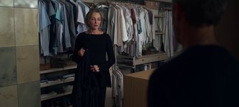 Movie still from “Chambers” (2019), created by Leah Rachel – A woman standing in front of a room full of clothes; Medium shot, Over the shoulder angle
