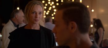 Movie still from “Chambers” (2019), created by Leah Rachel – A woman standing next to a man in front of lights; Close Up shot, Over the shoulder angle