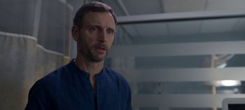 Movie still from “Chambers” (2019), created by Leah Rachel – A person wearing a blue shirt; Close Up shot, Over the shoulder angle