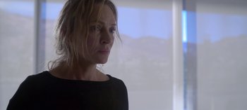 Movie still from “Chambers” (2019), created by Leah Rachel – A person wearing a black shirt near a window; Close Up shot, Low angle