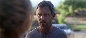Movie still from “Chambers” (2019), created by Leah Rachel – A person wearing a gray shirt; Close Up shot, Over the shoulder angle
