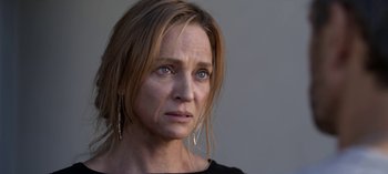 Movie still from “Chambers” (2019), created by Leah Rachel – A person wearing a black shirt; Close Up shot, Over the shoulder angle