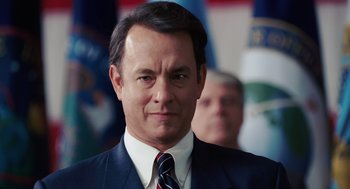 Movie still from “Charlie Wilson's War” (2007), directed by Mike Nichols – A man in a suit and tie looking at the camera; Close Up shot, Low angle