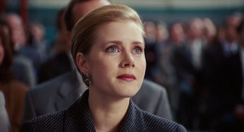 Movie still from “Charlie Wilson's War” (2007), directed by Mike Nichols – A person wearing a suit and tie; Close Up shot, Low angle