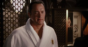 Movie still from “Charlie Wilson's War” (2007), directed by Mike Nichols – A man in a white bathrobe in front of a mirror; Close Up shot, Over the shoulder angle
