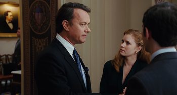Movie still from “Charlie Wilson's War” (2007), directed by Mike Nichols – A man and a woman in business attire talking to each other; Medium shot, Over the shoulder angle