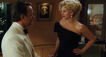 Movie still from “Charlie Wilson's War” (2007), directed by Mike Nichols – A man and a woman in a black dress; Medium shot, Over the shoulder angle