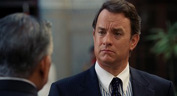 Movie still from “Charlie Wilson's War” (2007), directed by Mike Nichols – A man in a suit and tie standing next to another man in a suit; Close Up shot, Over the shoulder angle