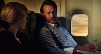 Movie still from “Charlie Wilson's War” (2007), directed by Mike Nichols – A man sitting on a seat on an airplane; Medium shot, Over the shoulder angle