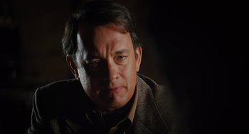 Movie still from “Charlie Wilson's War” (2007), directed by Mike Nichols – A person wearing a suit and tie; Close Up shot, Over the shoulder angle