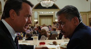 Movie still from “Charlie Wilson's War” (2007), directed by Mike Nichols – Two men sitting at a dinner table talking to each other; Close Up shot, Over the shoulder angle