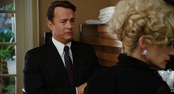 Movie still from “Charlie Wilson's War” (2007), directed by Mike Nichols – A man in a business suit and a woman in a black suit; Close Up shot, Over the shoulder angle