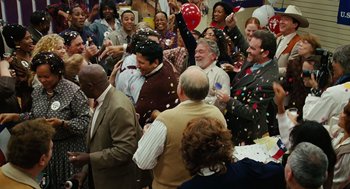 Movie still from “Charlie Wilson's War” (2007), directed by Mike Nichols – A group of people standing around each other at an event; Wide shot, High angle