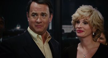 Movie still from “Charlie Wilson's War” (2007), directed by Mike Nichols – A man and a woman standing next to each other; Close Up shot, Over the shoulder angle