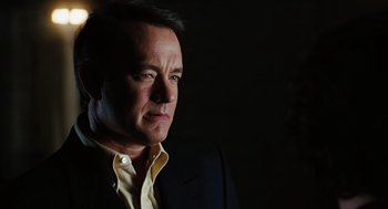 Movie still from “Charlie Wilson's War” (2007), directed by Mike Nichols – A person wearing a suit and tie; Close Up shot, Over the shoulder angle