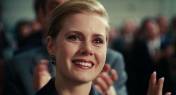 Movie still from “Charlie Wilson's War” (2007), directed by Mike Nichols – A person smiling at the camera; Close Up shot, Over the shoulder angle
