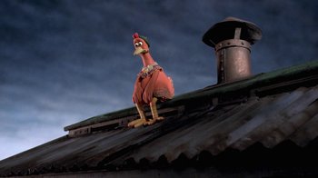 Movie still from “Chicken Run” (2000), directed by Peter Lord – A chicken statue on the roof of a building; Medium shot, Low angle