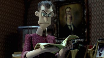 Movie still from “Chicken Run” (2000), directed by Peter Lord – A man in a suit reading a magazine; Close Up shot, Over the shoulder angle