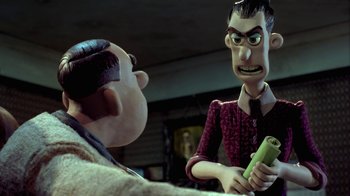 Movie still from “Chicken Run” (2000), directed by Peter Lord – A man is talking to another man in a room; Medium shot, Over the shoulder angle
