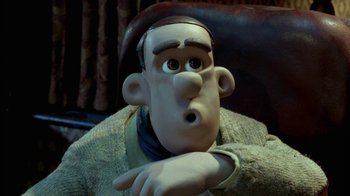 Movie still from “Chicken Run” (2000), directed by Peter Lord – The head and arm of a cartoon character; Close Up shot, High angle