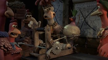 Movie still from “Chicken Run” (2000), directed by Peter Lord – A group of cartoon characters sitting on a wooden machine; Medium shot, High angle