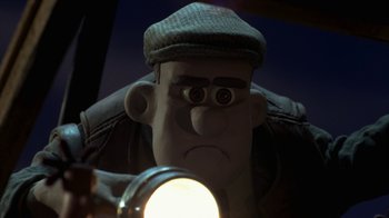 Movie still from “Chicken Run” (2000), directed by Peter Lord – A cartoon character looking in a magnifying glass; Close Up shot, Low angle