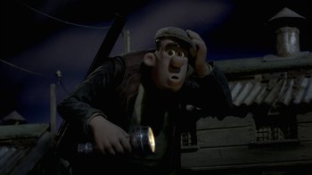 Movie still from “Chicken Run” (2000), directed by Peter Lord – A man with a flashlight in his hand is looking up; Medium shot, Low angle