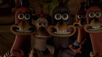Movie still from “Chicken Run” (2000), directed by Peter Lord – A group of cartoon characters with goofy faces; Close Up shot, High angle