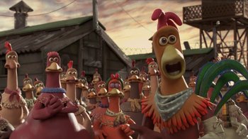 Movie still from “Chicken Run” (2000), directed by Peter Lord – A bunch of chickens that are standing in a field; Close Up shot, High angle