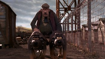 Movie still from “Chicken Run” (2000), directed by Peter Lord – A man riding on the back of two dogs; Wide shot, Low angle