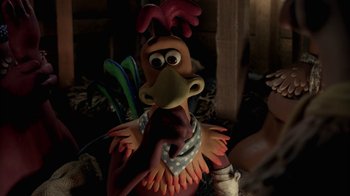 Movie still from “Chicken Run” (2000), directed by Peter Lord – A toy chicken with a candle in the background; Close Up shot, High angle