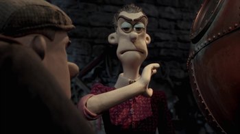 Movie still from “Chicken Run” (2000), directed by Peter Lord – A cartoon character with his arm outstreched; Close Up shot, Over the shoulder angle