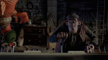 Movie still from “Chicken Run” (2000), directed by Peter Lord – A man in a hat is holding a screwdriver; Medium shot, Low angle