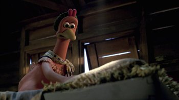 Movie still from “Chicken Run” (2000), directed by Peter Lord – A toy chicken is standing in front of a table; Close Up shot, High angle