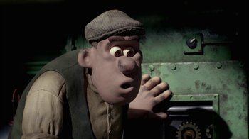 Movie still from “Chicken Run” (2000), directed by Peter Lord – A man in a brown hat and a brown vest; Close Up shot, Low angle