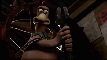Movie still from “Chicken Run” (2000), directed by Peter Lord – A statue of a chicken holding a wrench; Extreme Close Up shot, High angle