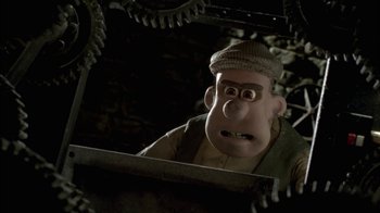 Movie still from “Chicken Run” (2000), directed by Peter Lord – A man with a hat is looking into a mirror; Close Up shot, Low angle