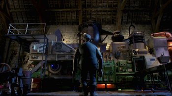 Movie still from “Chicken Run” (2000), directed by Peter Lord – A man standing next to a machine in a room; Wide shot, Low angle
